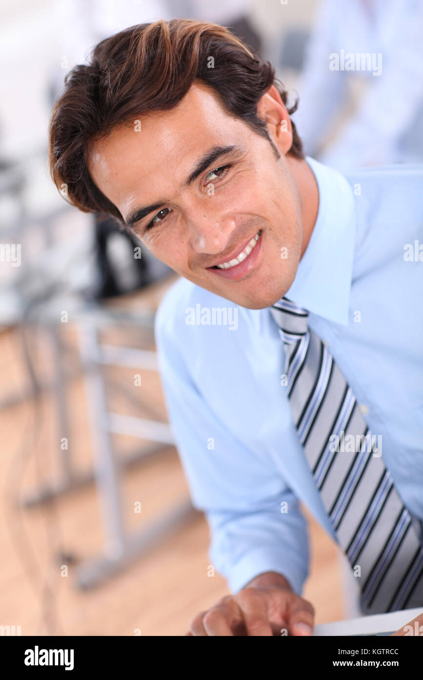 Portrait of smiling businessman in office Stock Photo - Alamy