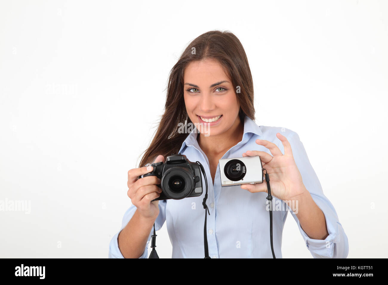 Woman Using Comparator Young woman comparing digital compact and reflex cameras Stock Photo ...