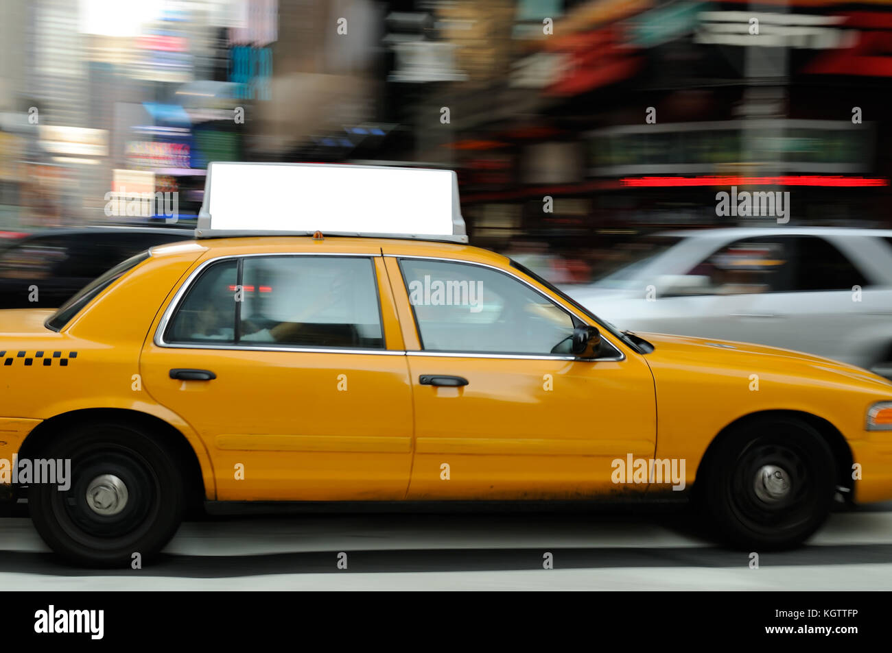 Taxi top advertising in Times Square, New York City. Blank display on yellow cab, motion blur background Stock Photo