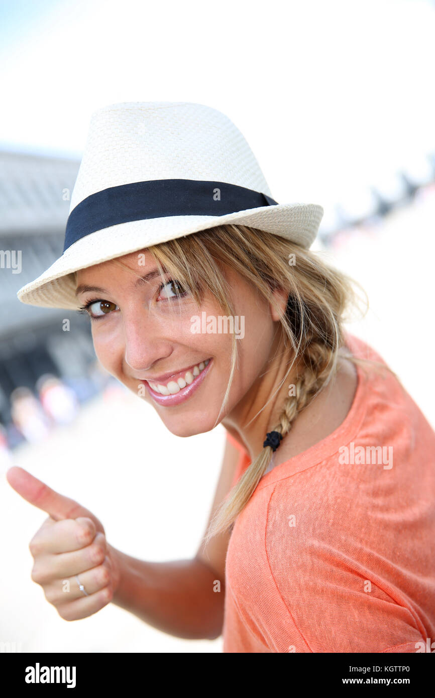 Smiling beautiful girl with hat showing thumb up Stock Photo - Alamy