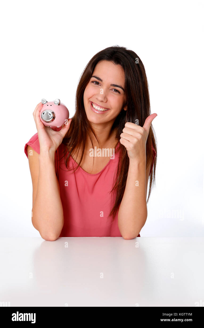 Girl holding piggy bank and showing thumb up Stock Photo - Alamy