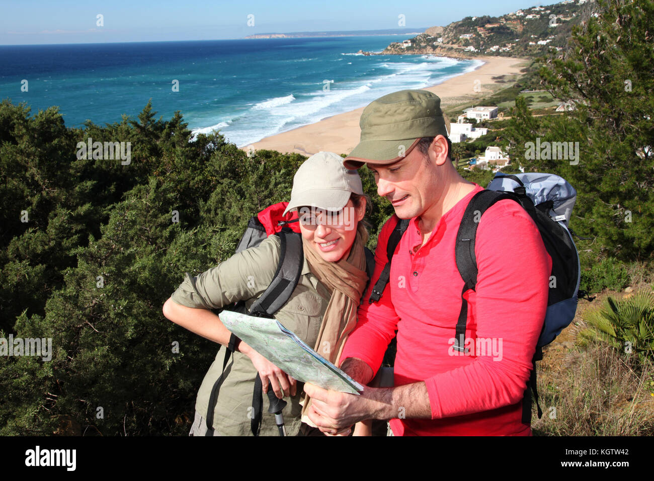 Couple looking at map on a hiking day Stock Photo - Alamy