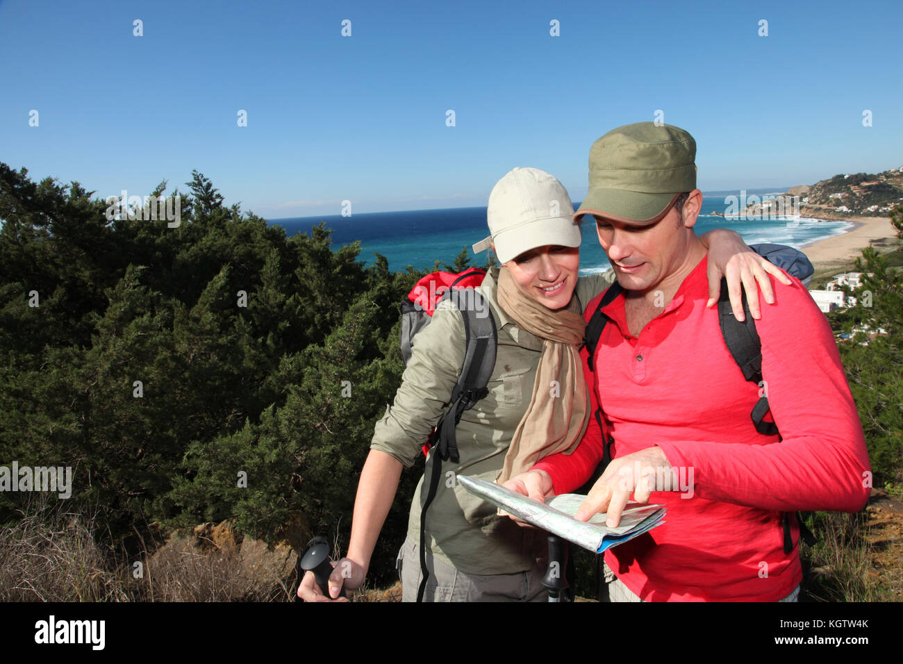Couple looking at map on a hiking day Stock Photo - Alamy