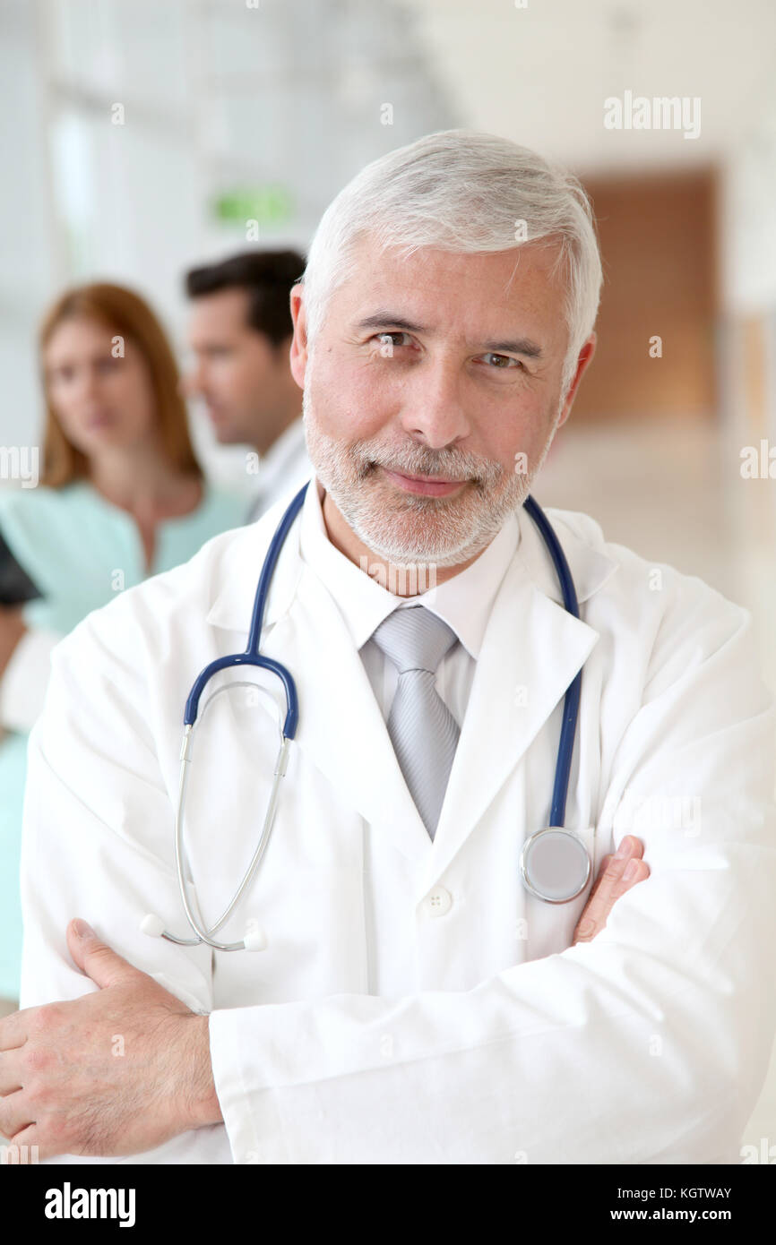 Portrait of smiling senior doctor Stock Photo - Alamy