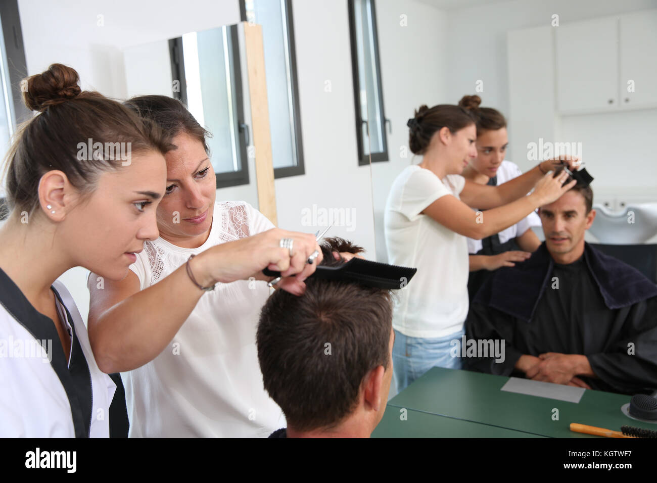 Student girl in hairdressing learning how to cut hair Stock Photo Alamy