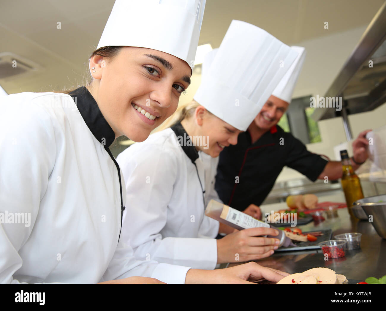 Team of young chefs preparing delicatessen dishes Stock Photo Alamy