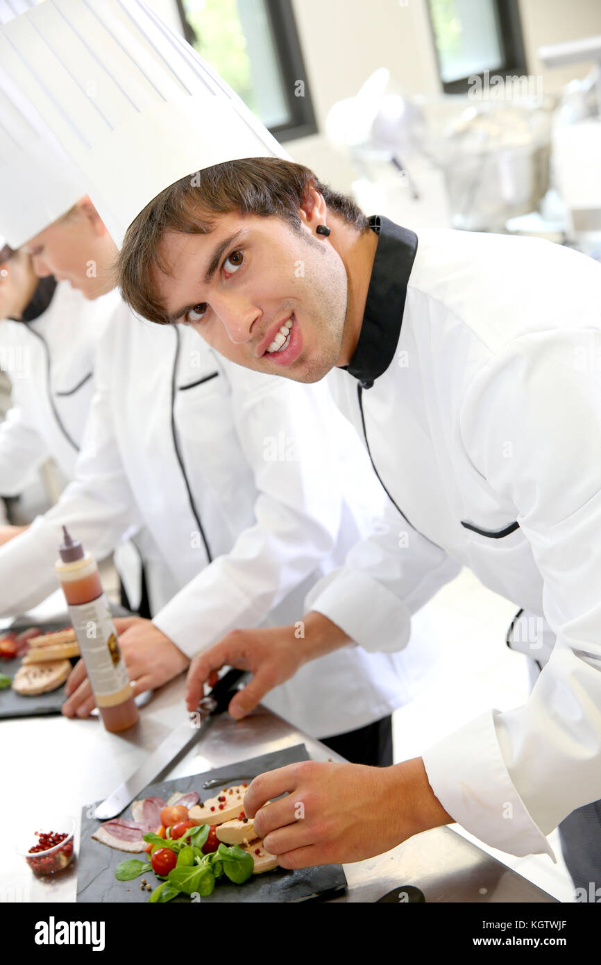 Smiling young man in restaurant kitchen Stock Photo