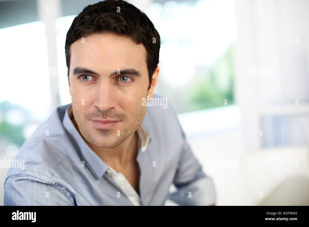 Portrait Of A Nice Young Attractive Man With Blue Eyes Stock Photo