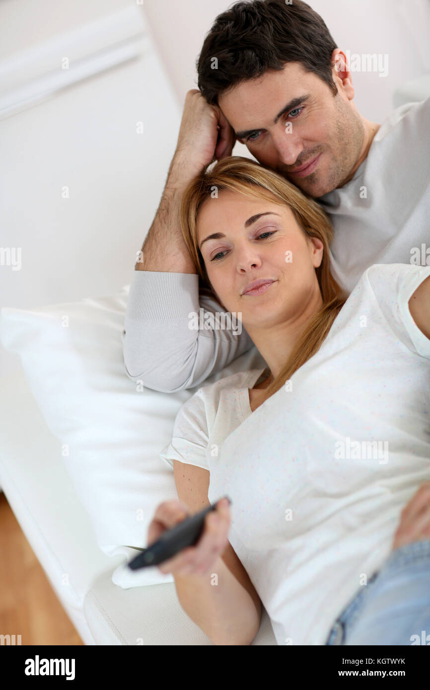 Sweet couple in sofa watching tv Stock Photo pic