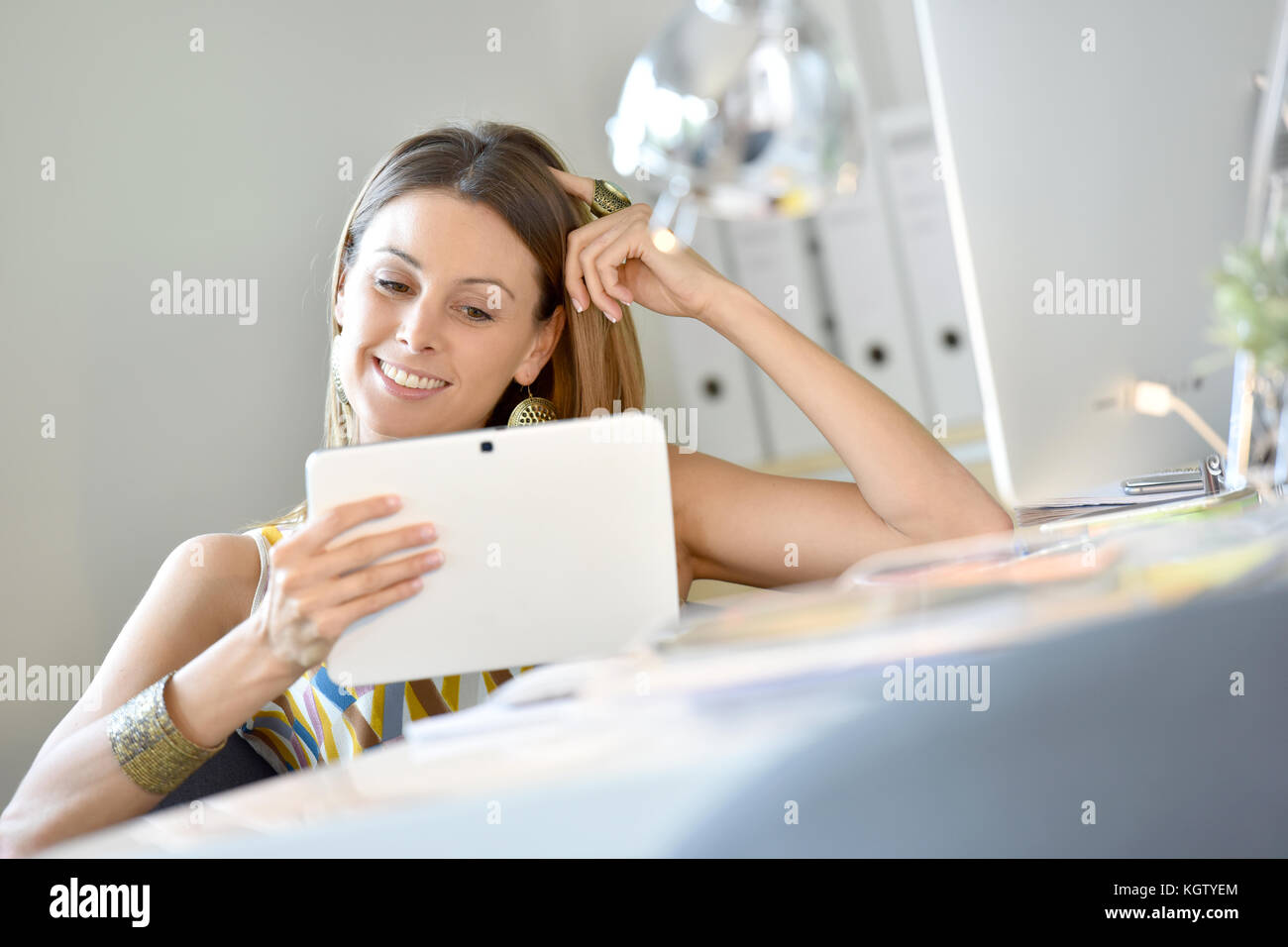 Woman in office using digital tablet Stock Photo - Alamy