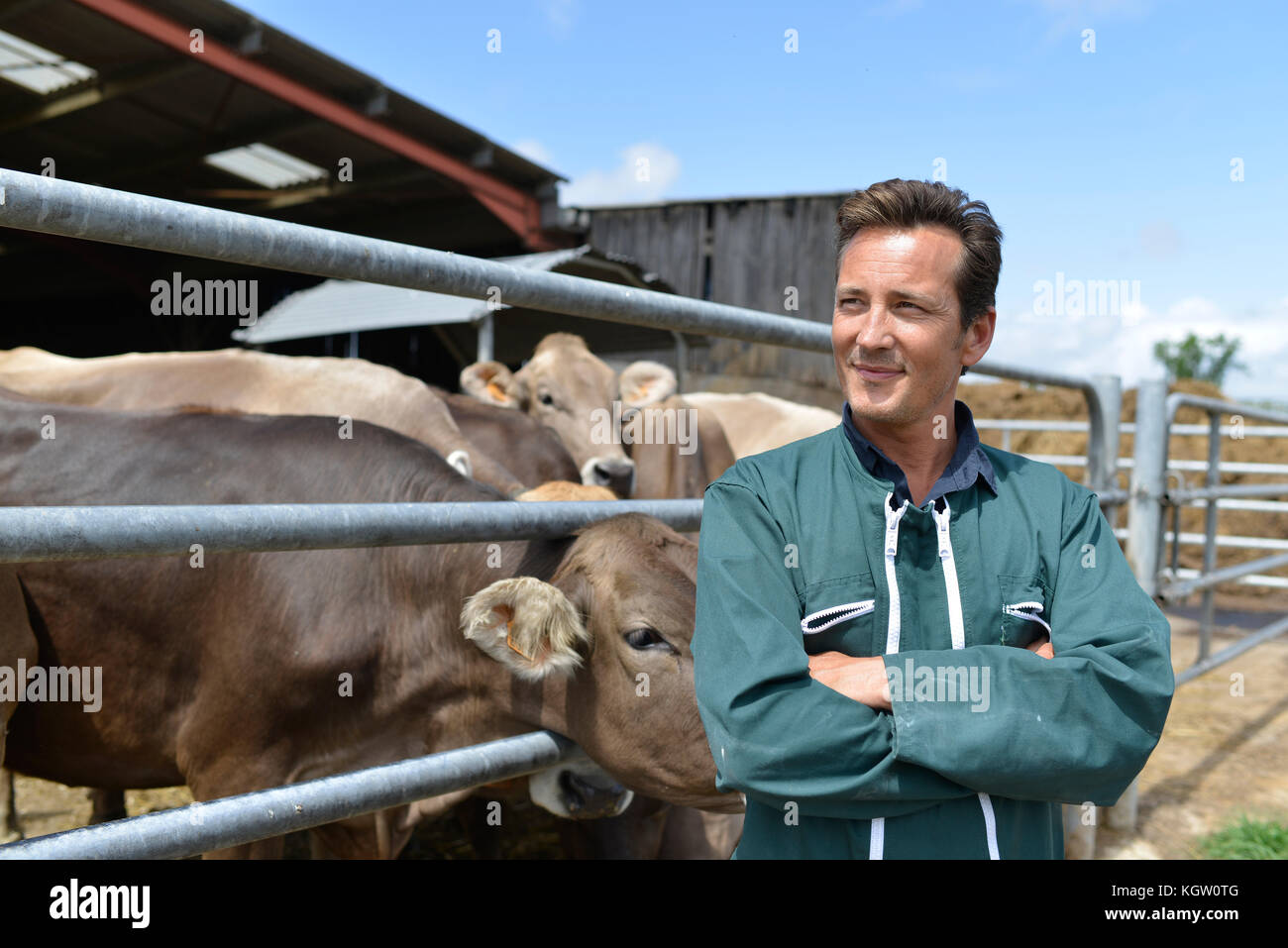 Portrait of smiling farmer standing by barn Stock Photo - Alamy
