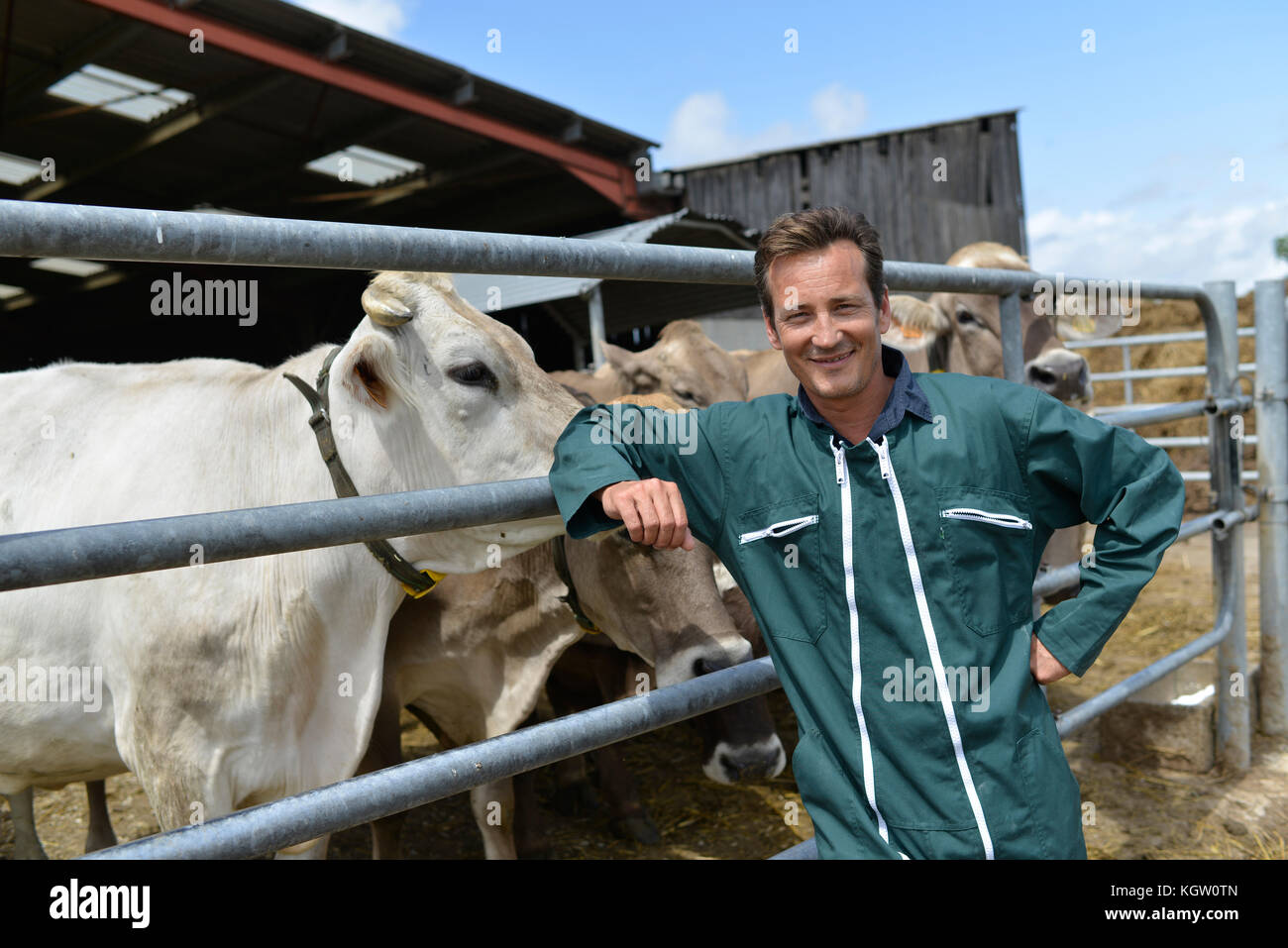 Portrait of smiling farmer standing by barn Stock Photo - Alamy