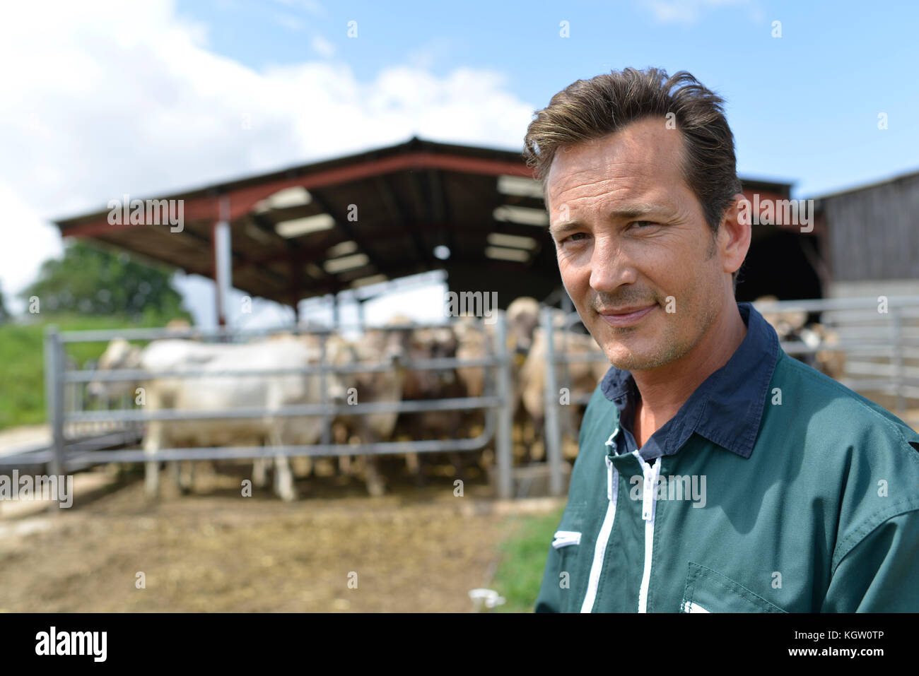 Portrait of smiling farmer standing by barn Stock Photo - Alamy