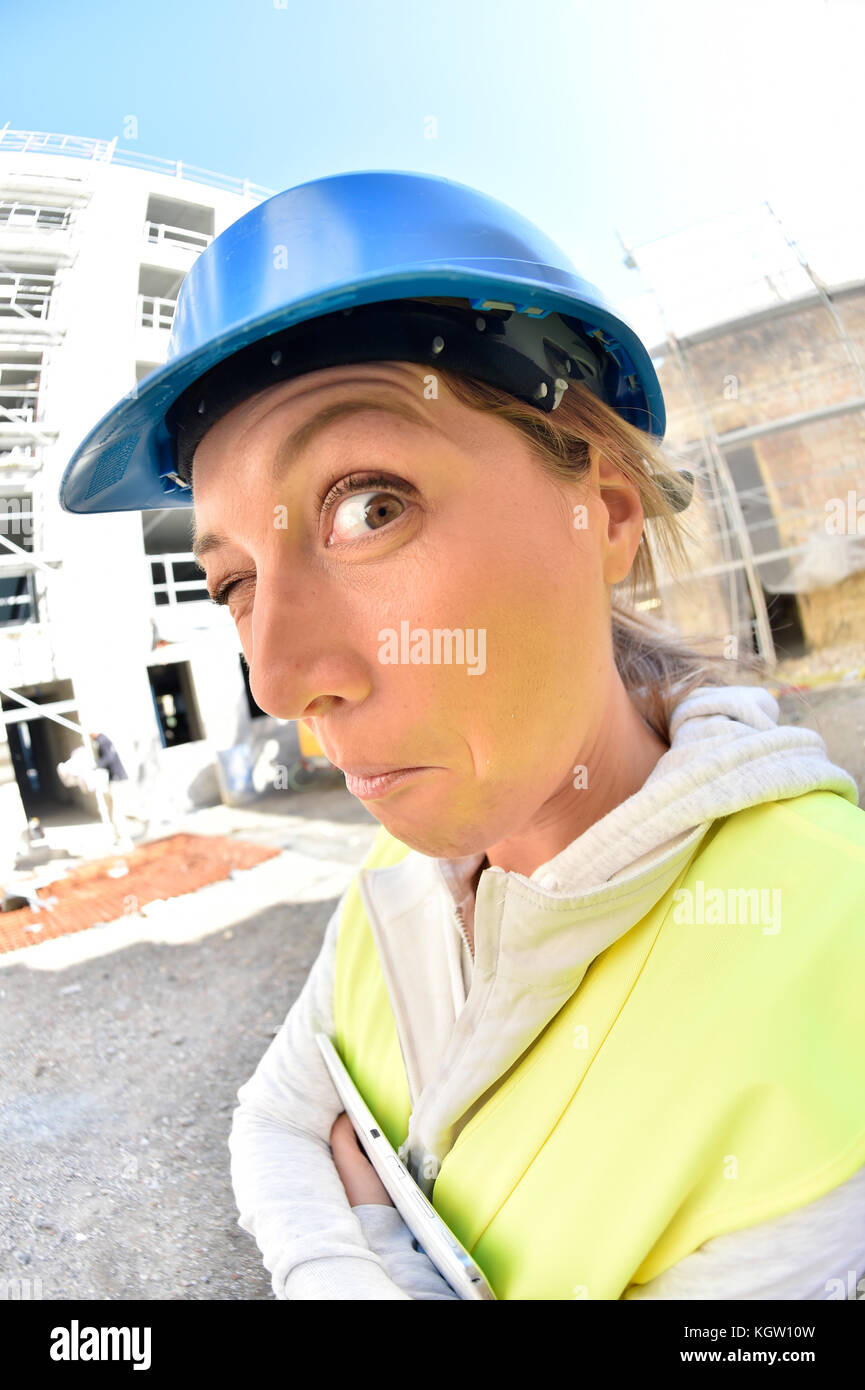Woman architect on building site- funny face Stock Photo