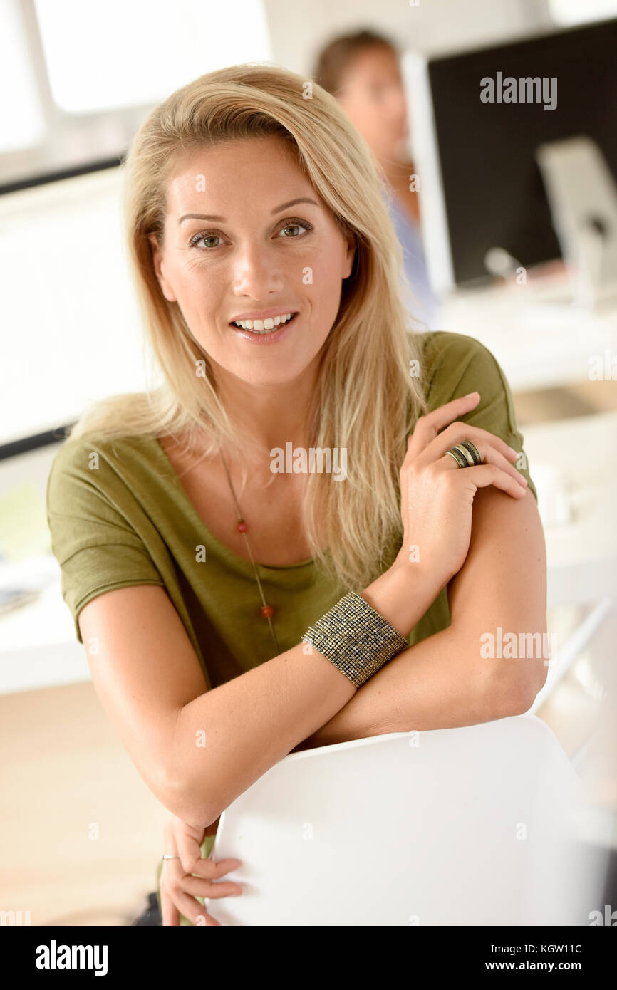 Portrait of smiling businesswoman in office Stock Photo - Alamy