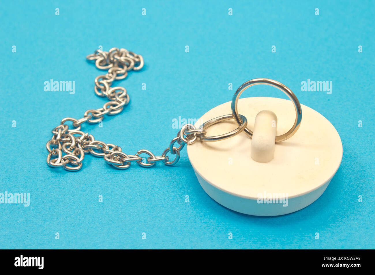 Sink plug with chain isolated on blue background Stock Photo