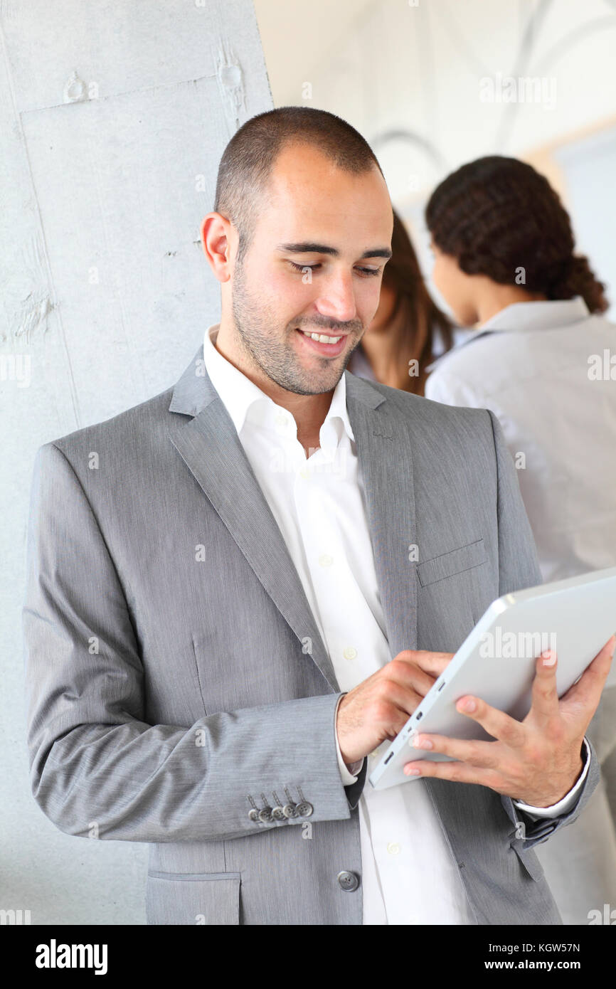 Young businessman using electronic tablet Stock Photo - Alamy
