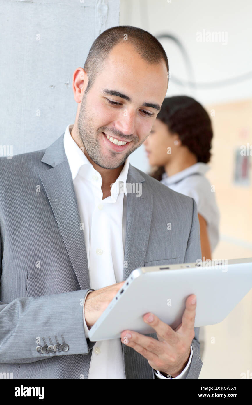 Young businessman using electronic tablet Stock Photo - Alamy