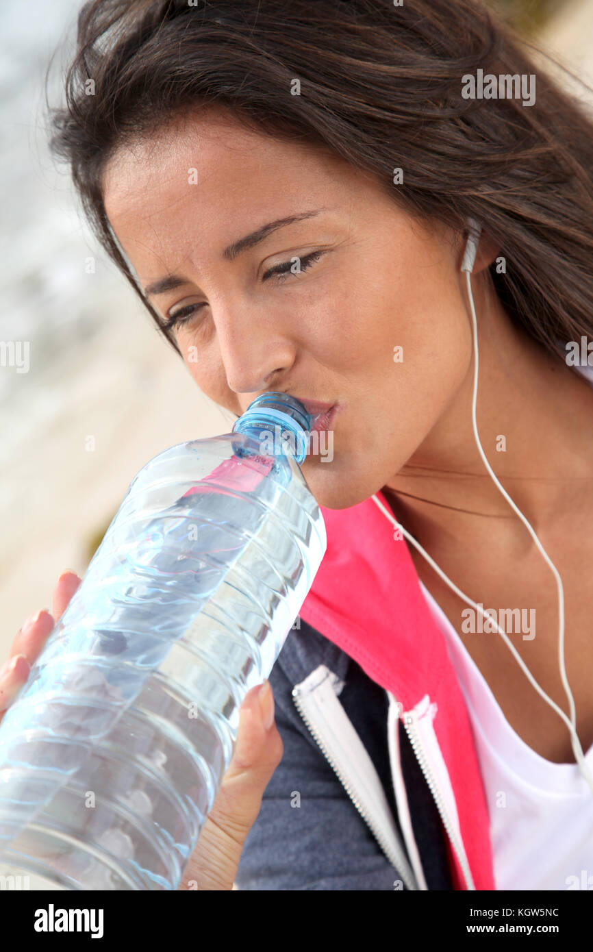 Portrait of jogger drinking water from bottle Stock Photo Alamy