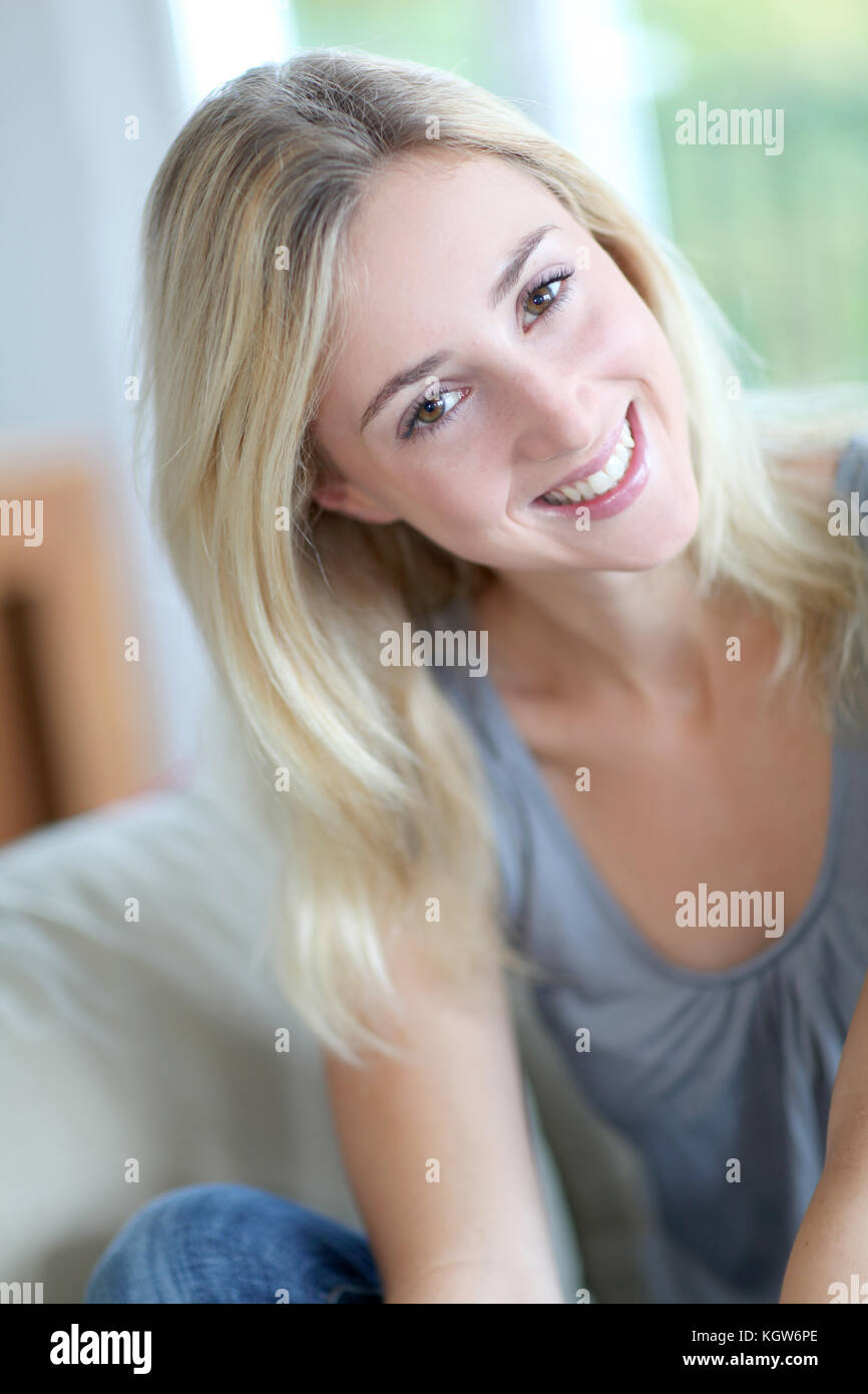 Beautiful smiling woman relaxing in sofa Stock Photo - Alamy
