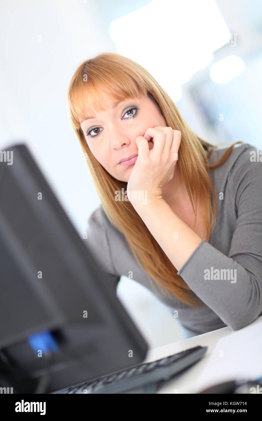 Bored woman at work Stock Photo - Alamy