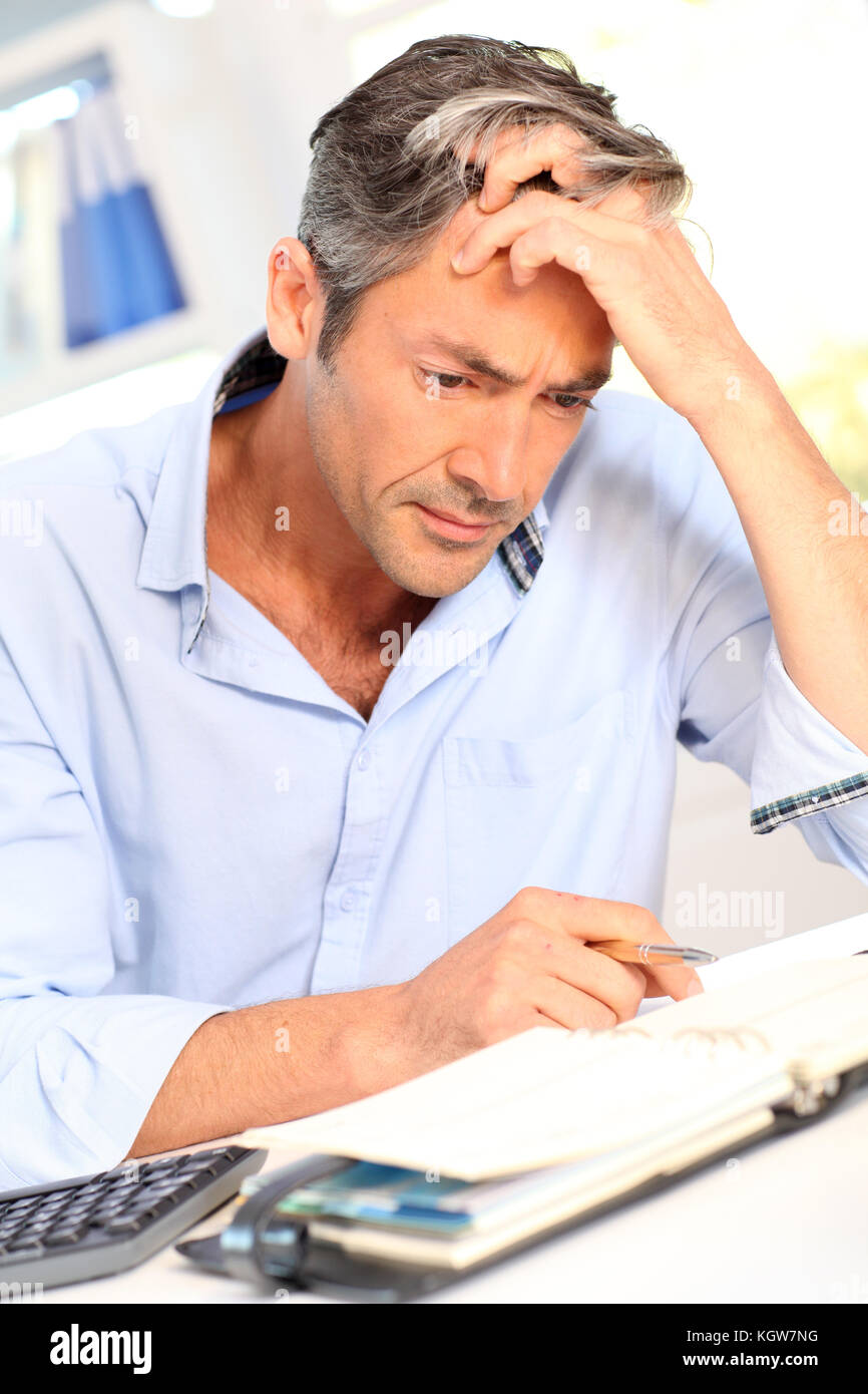 Man in office with worried look on his face Stock Photo Alamy