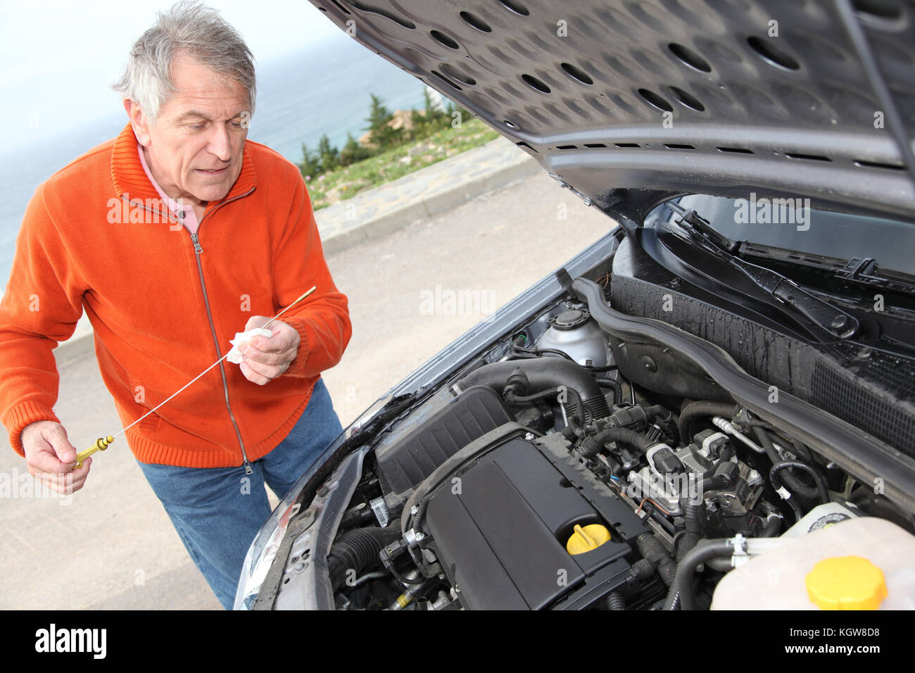 Senior man checking car motor levels Stock Photo - Alamy