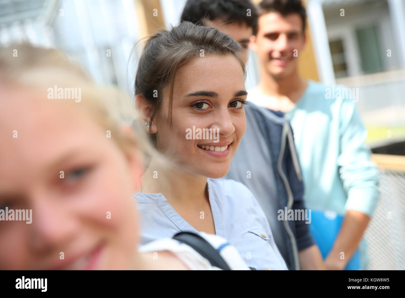 Portrait of smiling school girl amongst group Stock Photo - Alamy
