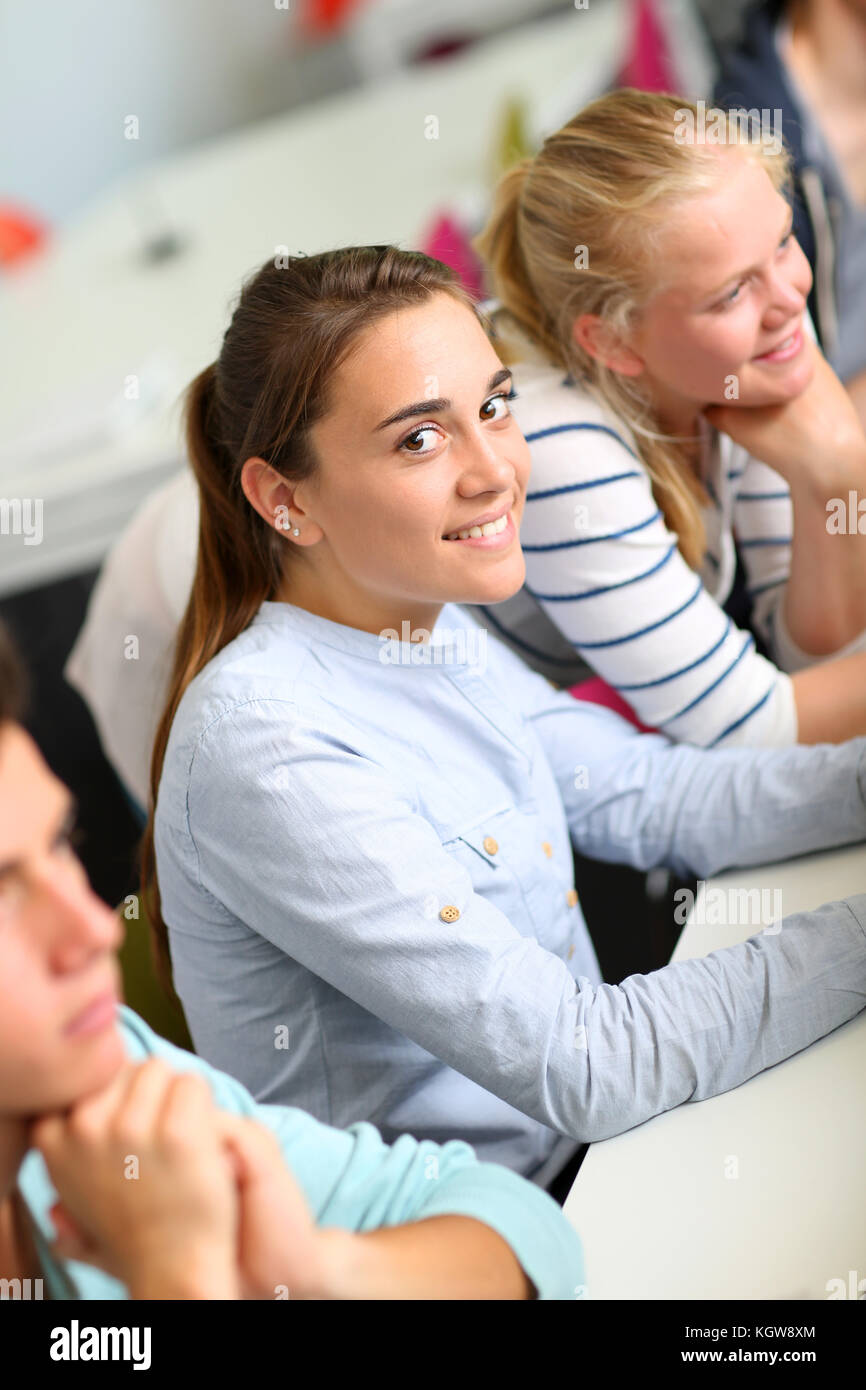 Portrait of cheerful student girl sitting in class Stock Photo - Alamy
