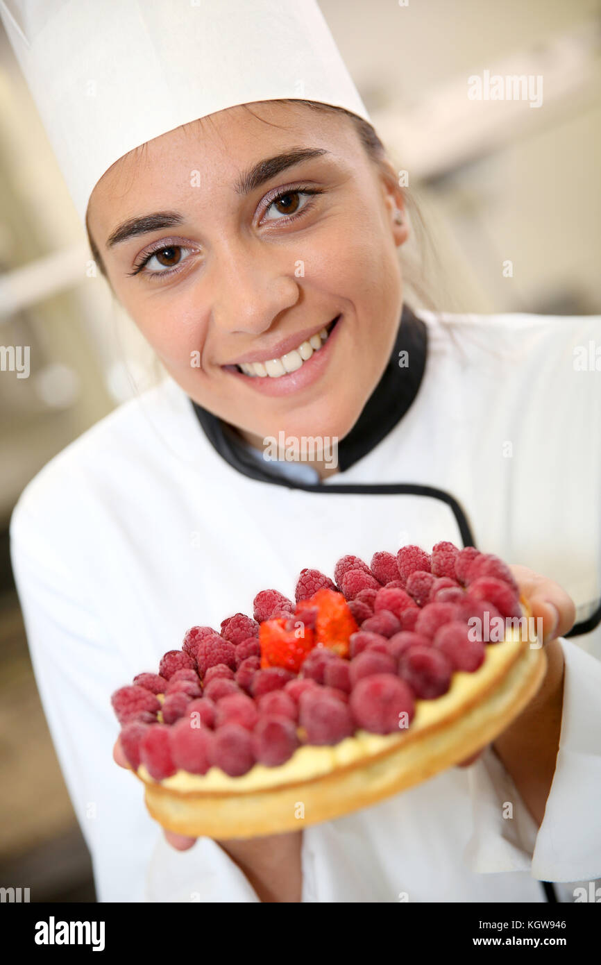 Portrait of pastry cook girl holding cake Stock Photo