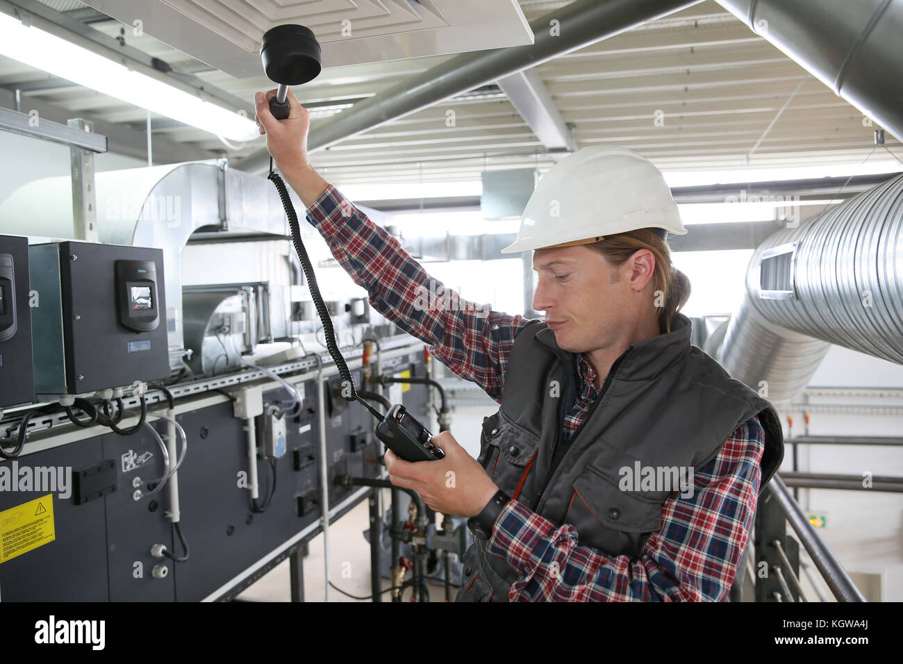 Technician controlling air quality of heating equipment Stock Photo
