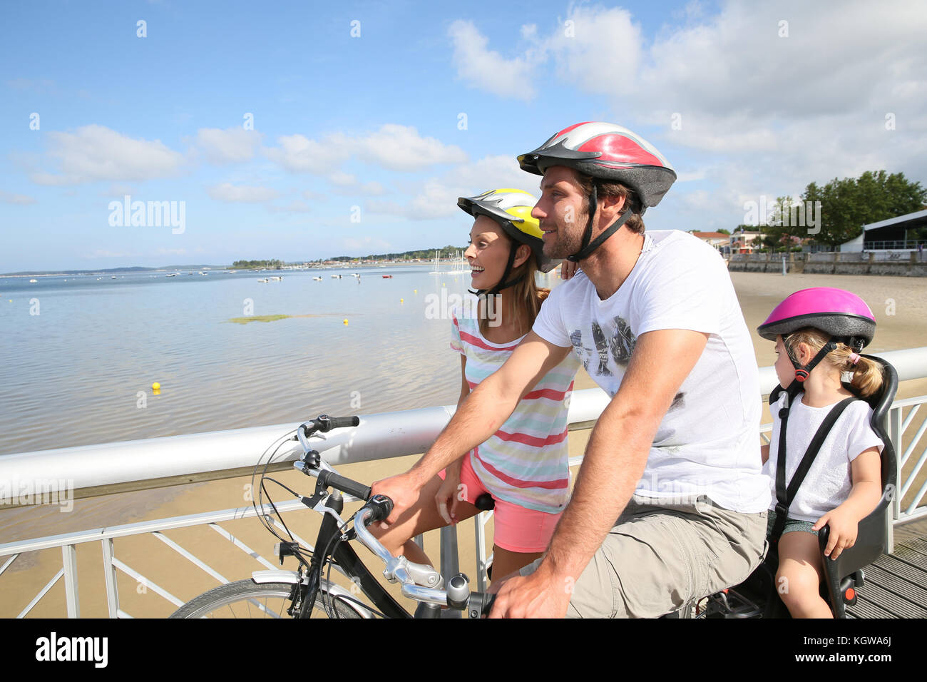 Family on a biking journey by the sea Stock Photo