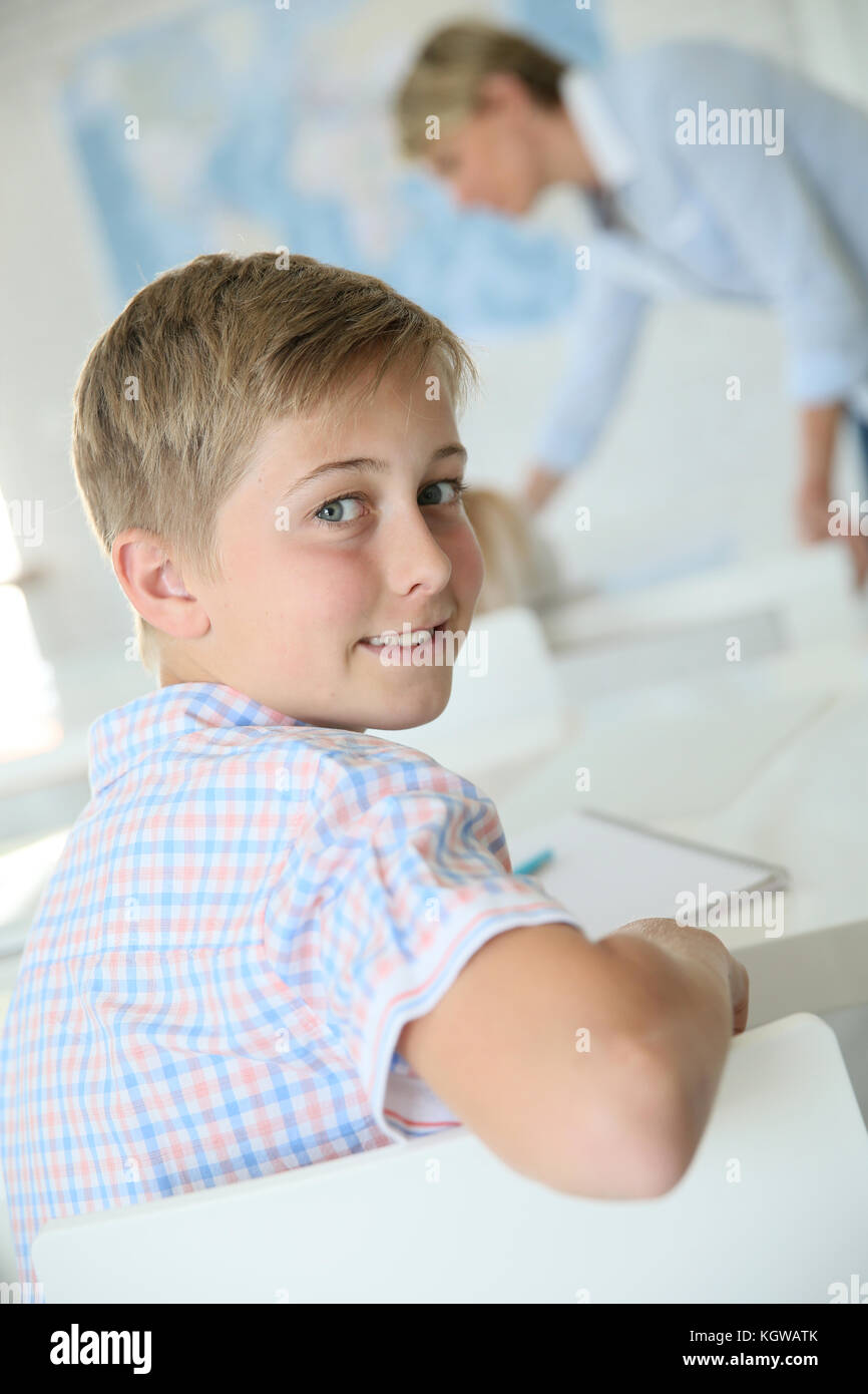 Young smiling schoolboy in classroom Stock Photo - Alamy