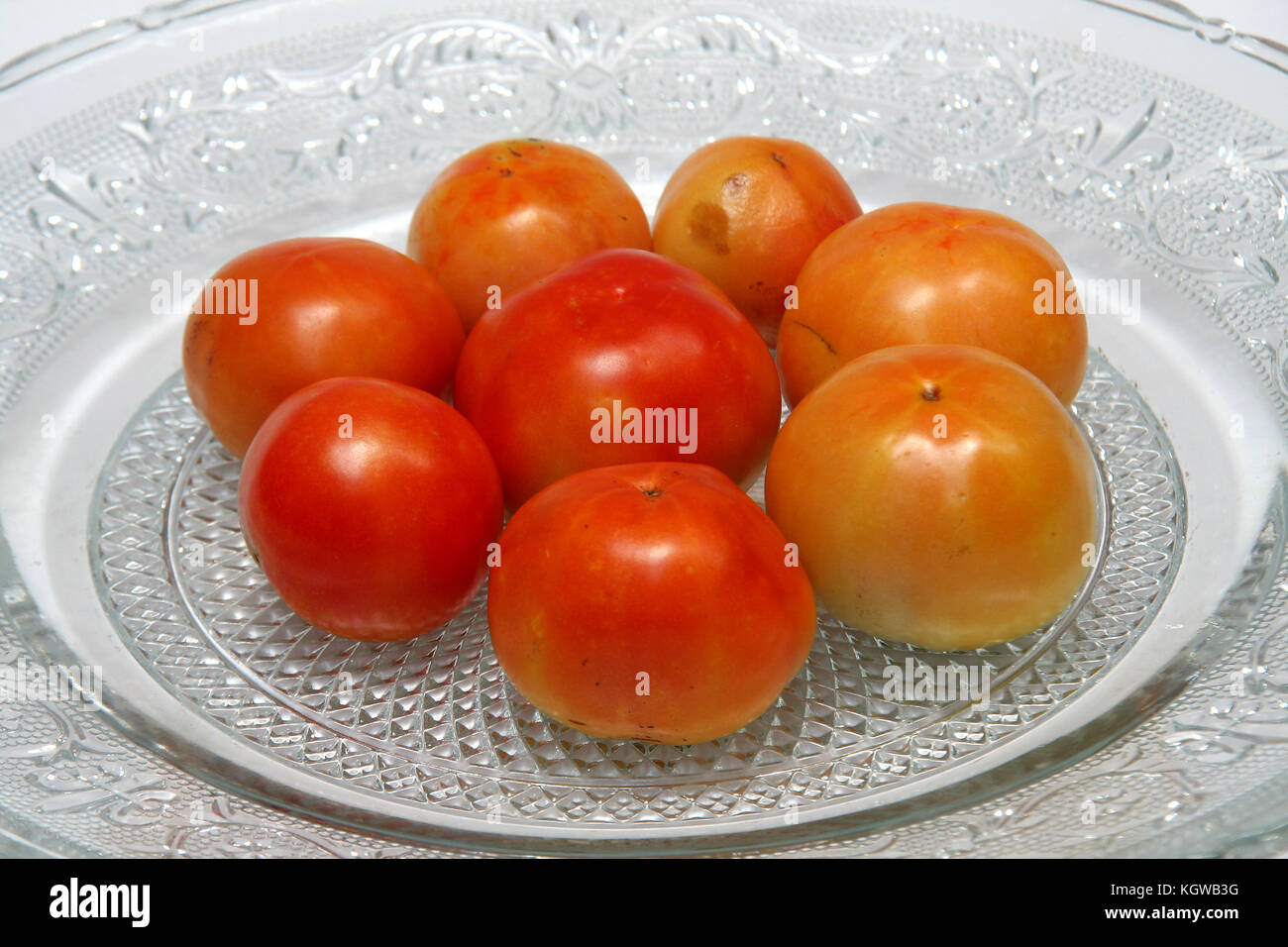 Tomatoes are red, yellow, sour, pulpy edible fruits containing vitamin C and betacarotene Stock