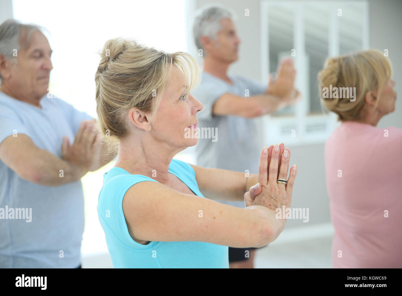 Group of senior people doing fitness exercises in gym Stock Photo