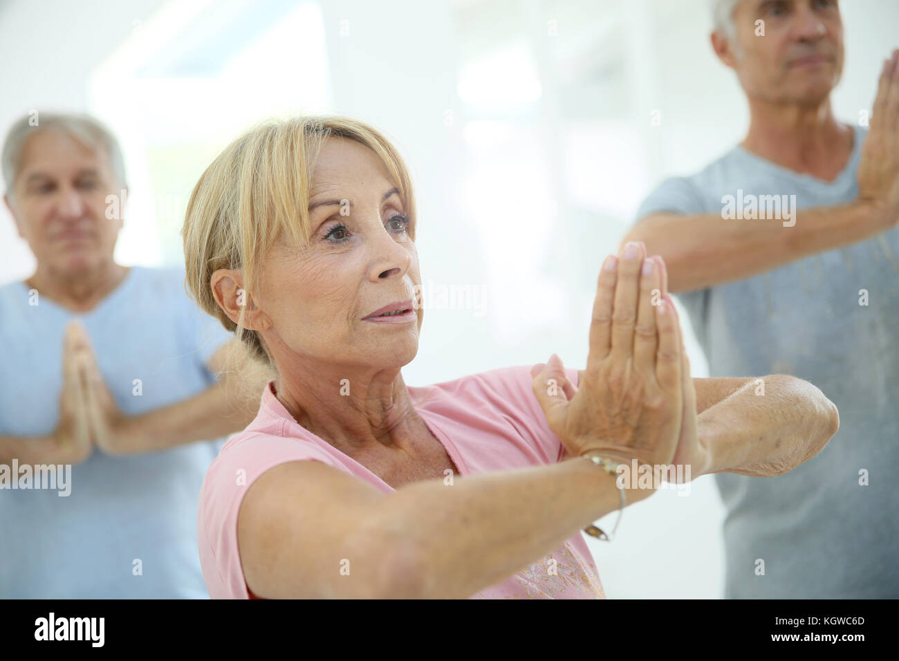 Group of senior people doing fitness exercises in gym Stock Photo