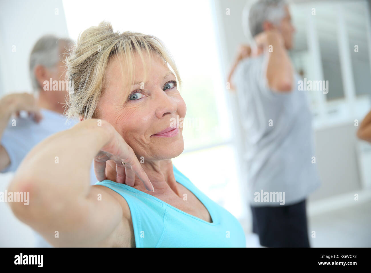 Senior people stretching out in fitness room Stock Photo