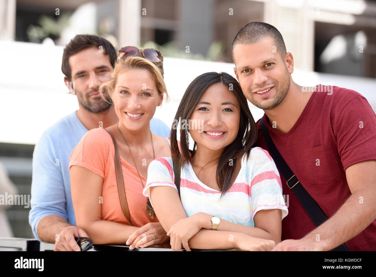 Group of young couples standing by building of apartments Stock Photo