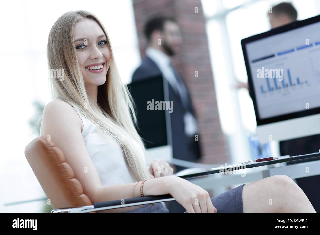 young business woman sitting at a desk in the office Stock Photo - Alamy