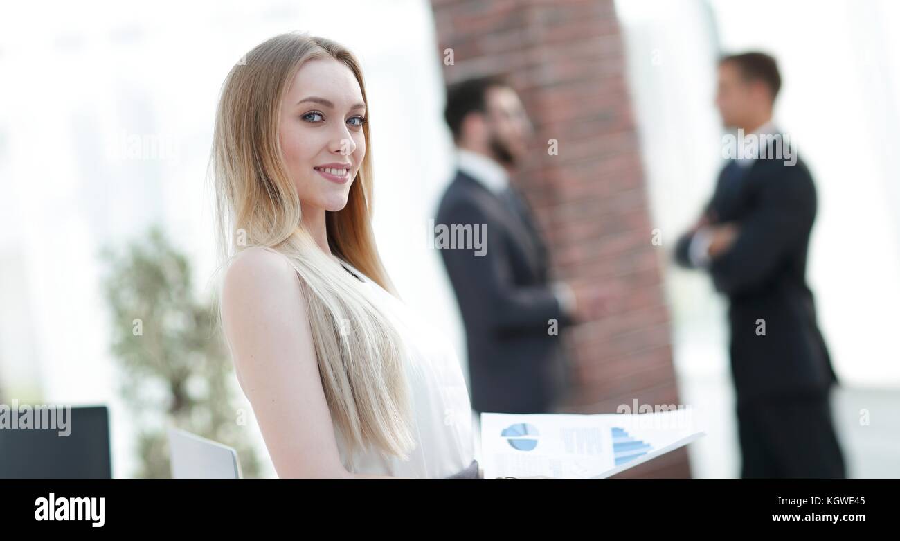 portrait of an elegant young business woman on the office background ...