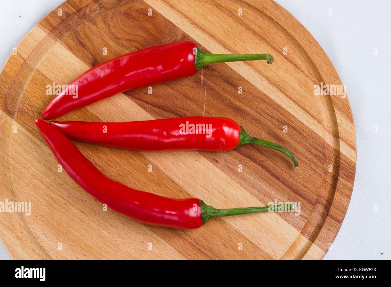 Hot chilli peppers on wooden board Stock Photo - Alamy