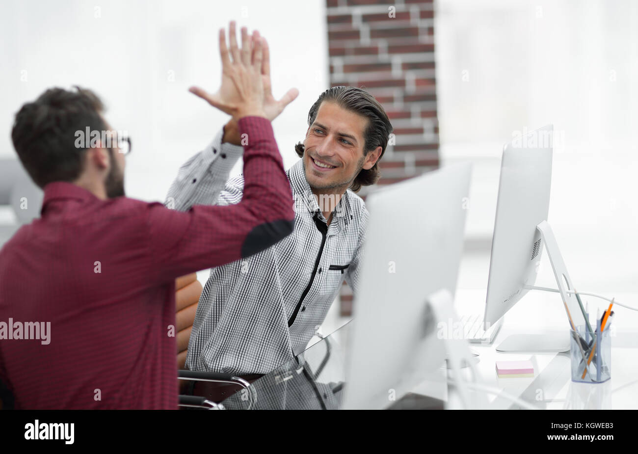 happy employees giving each other high five Stock Photo - Alamy
