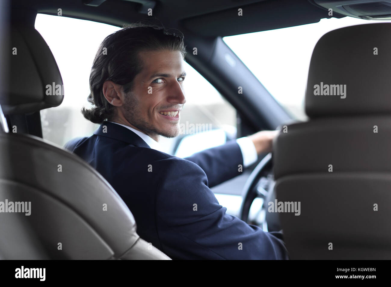 man sitting behind the wheel of a car Stock Photo - Alamy