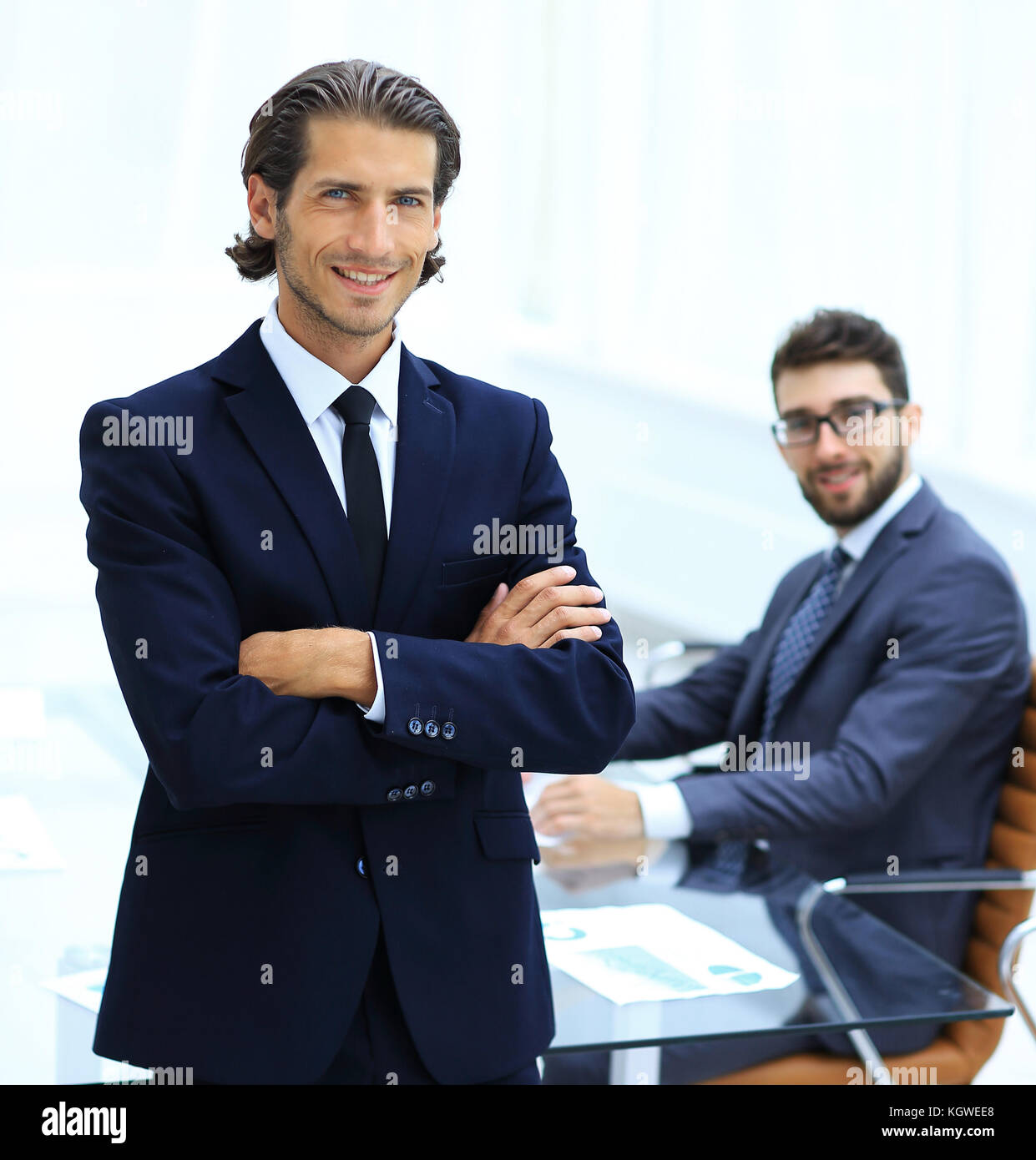 Portrait of businessman standing in office Stock Photo - Alamy