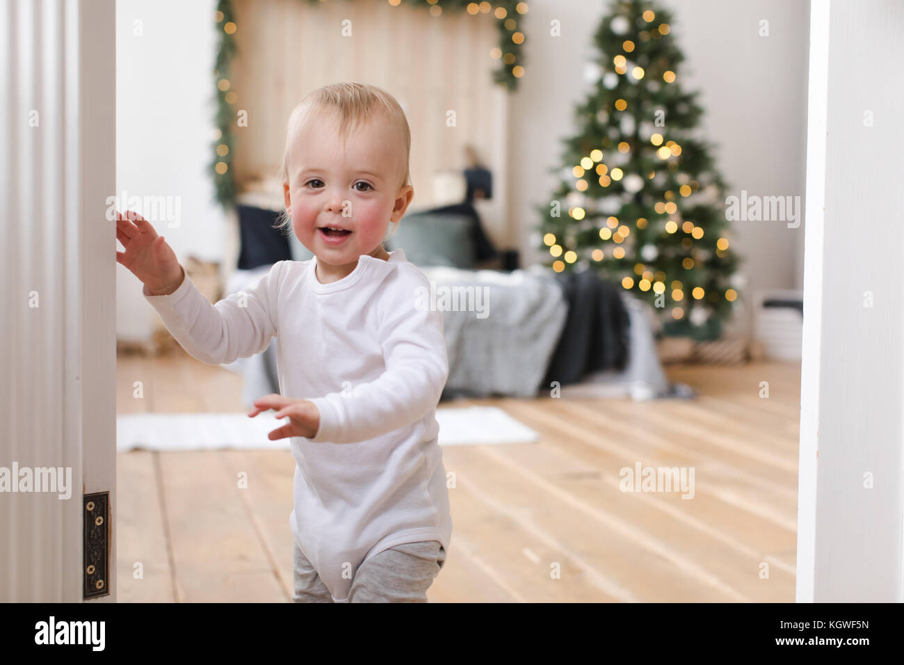 Charming kid in doorway of cozy bedroom Stock Photo Alamy