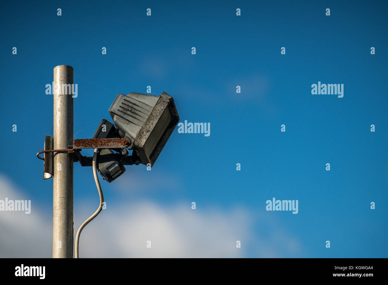 Automatic safety light attached to the metal pole with blue sky