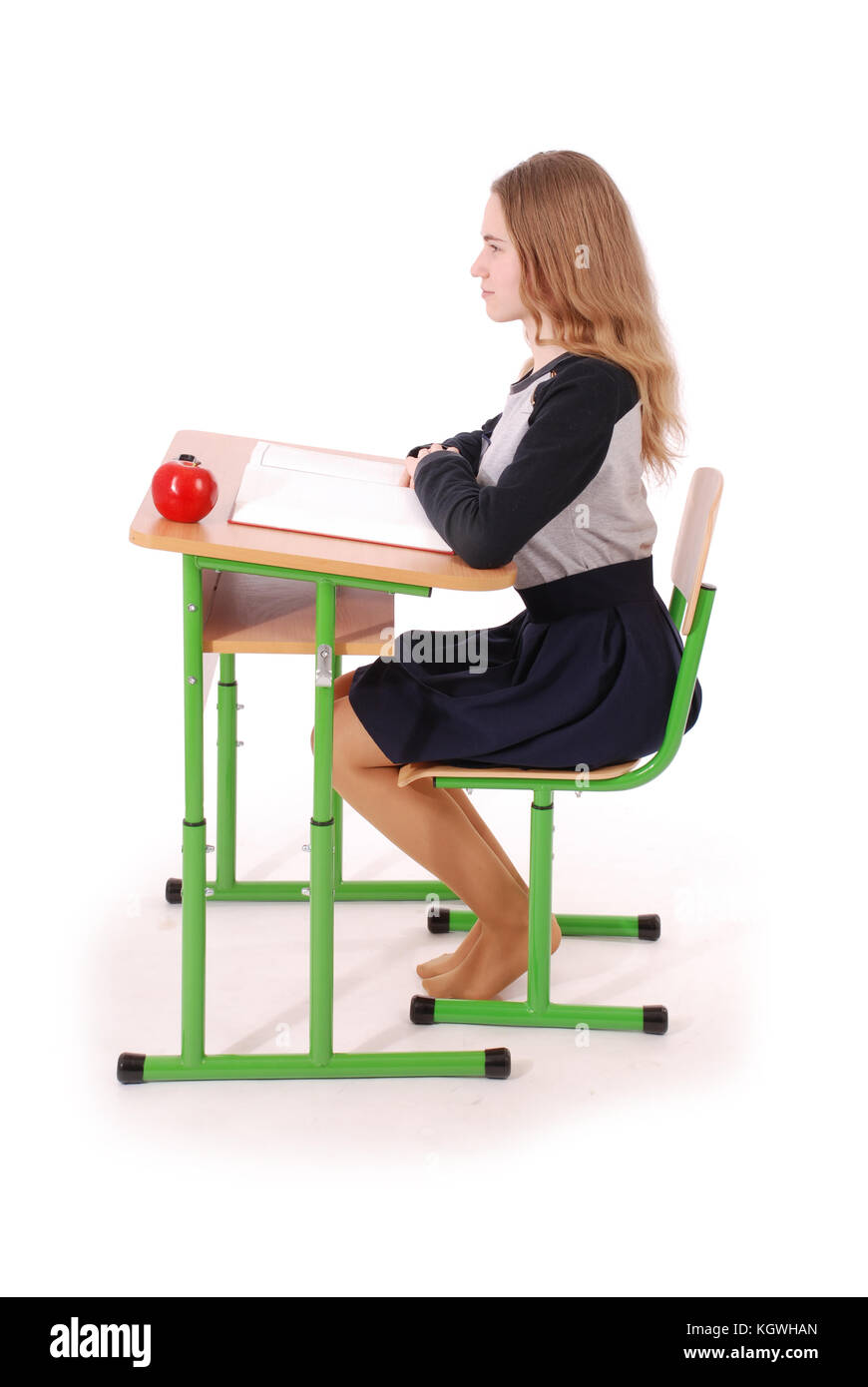 School girl sitting at a desk isolated on white Stock Photo - Alamy