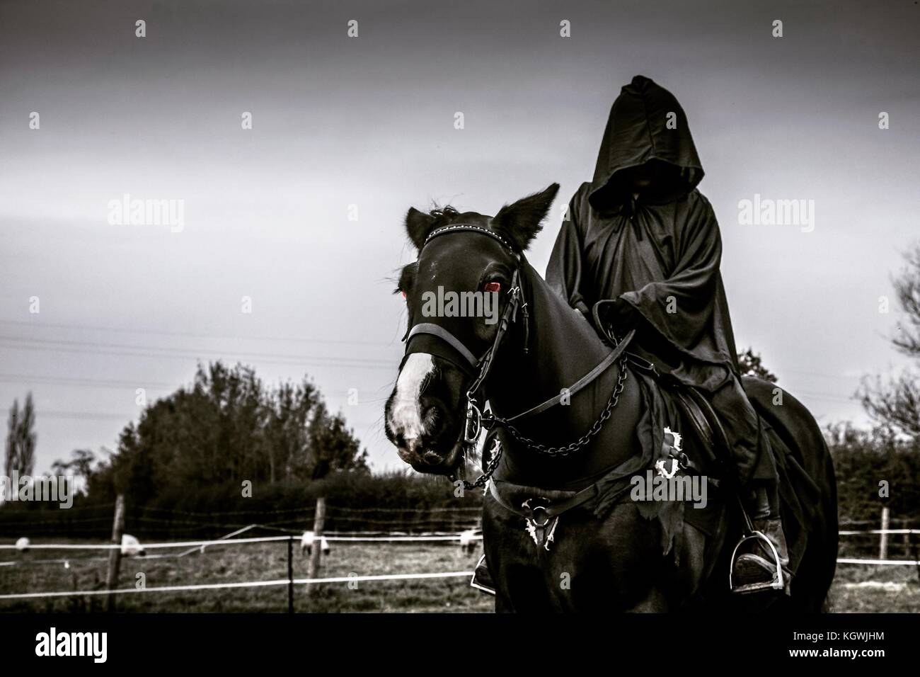 Hooded figure on horse back Stock Photo