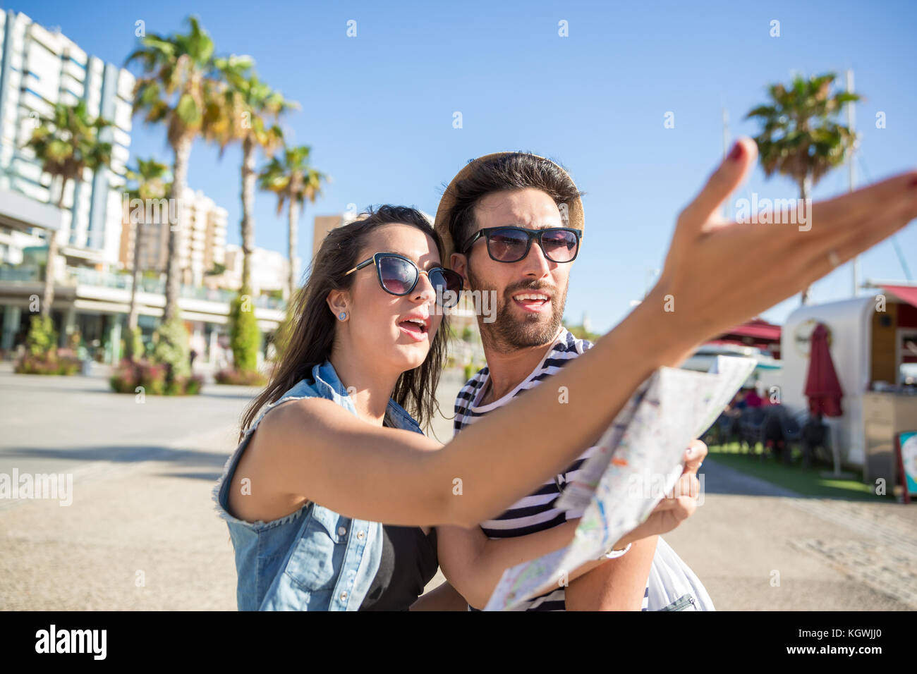 Portrait of couple holding map discussing about the road Stock Photo