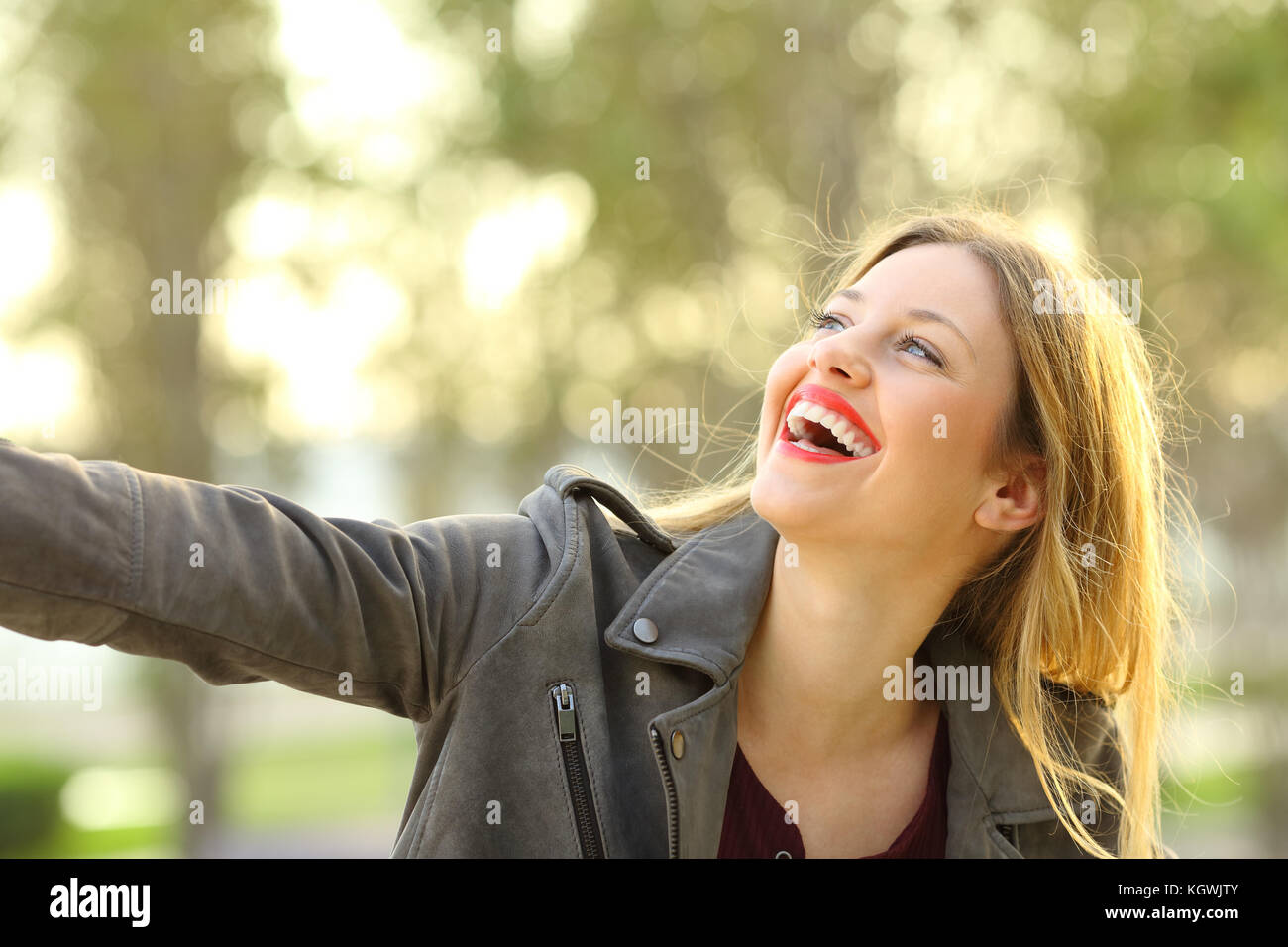 Portrait of a candid girl laughing and joking outdoors in a park Stock Photo